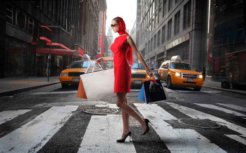 Woman in red dress crossing street
