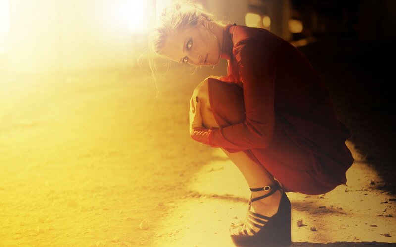 woman in red dress crouching