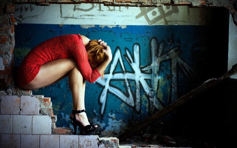 Woman in red dress crouching