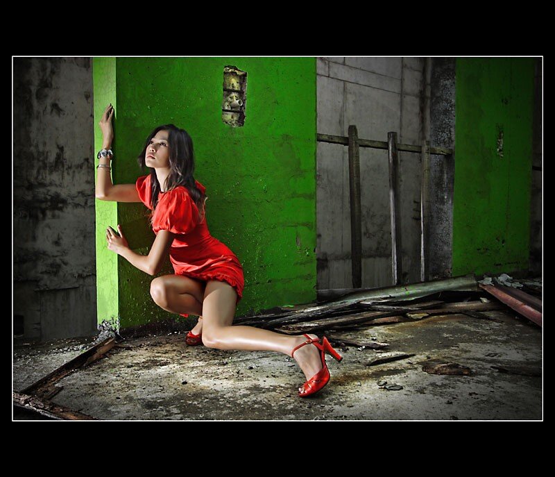 woman in red dress crouching