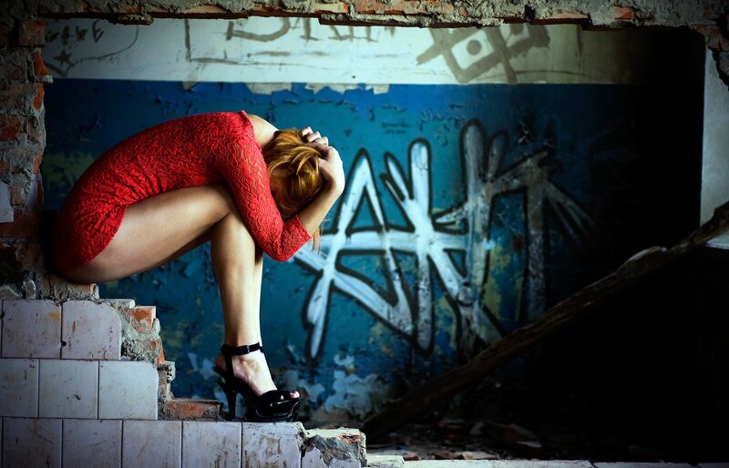 Woman in red dress crouching
