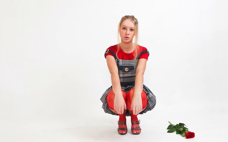 woman in red dress crouching