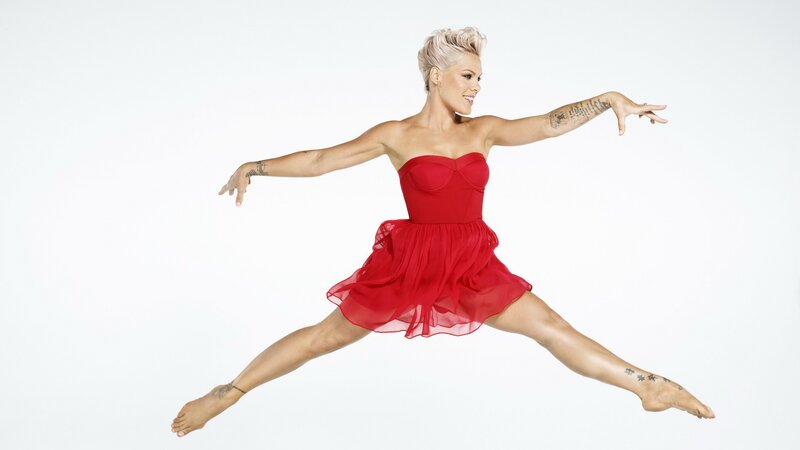 woman in red dress dancing
