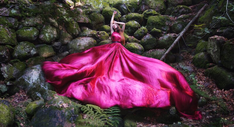 Woman in Red Dress — Dramatic, Photograph, Mossy Rocks