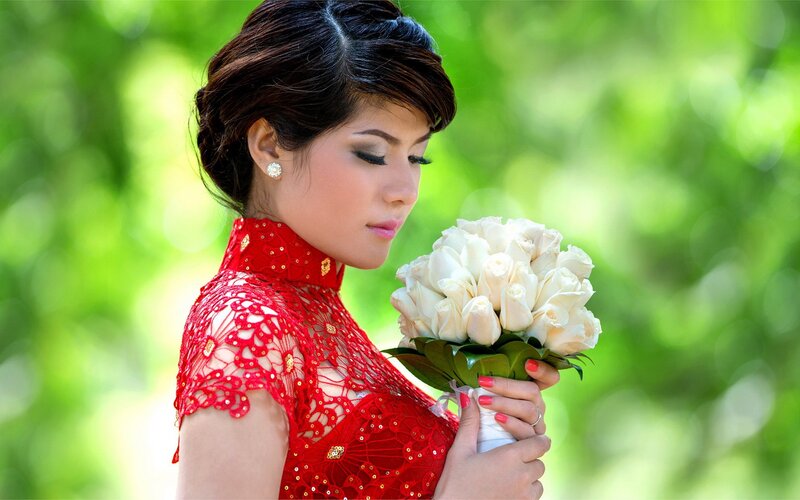 woman in red dress holding flowers