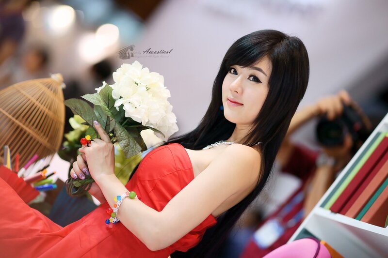 woman in red dress holding flowers
