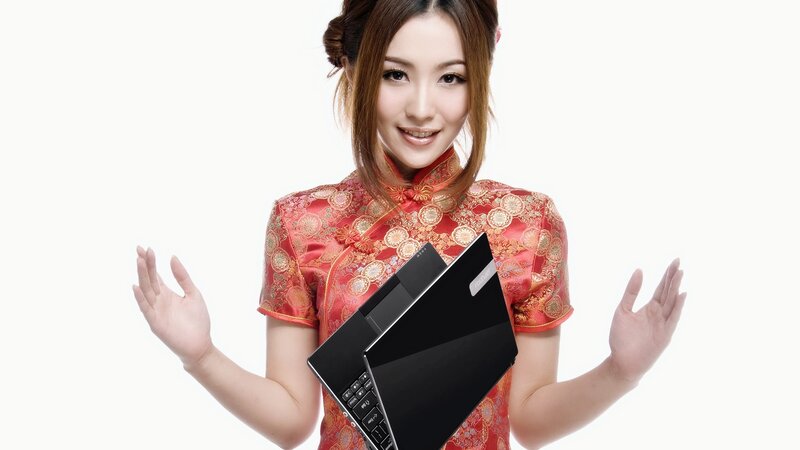 woman in red dress holding laptop