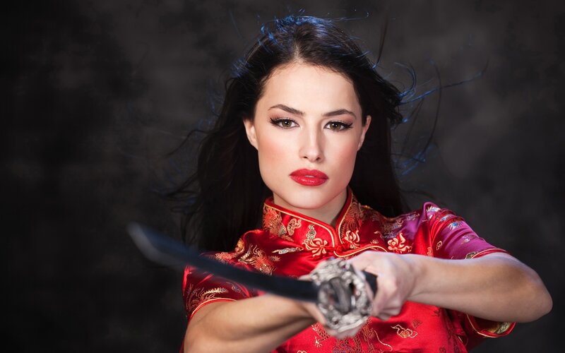 woman in red dress holding sword