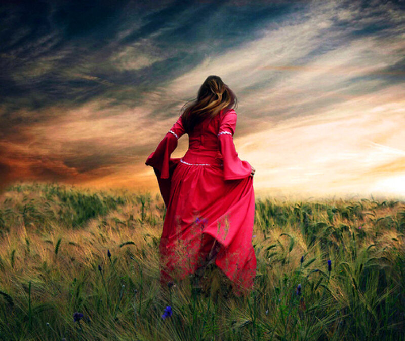 Woman in red dress in a field