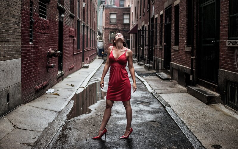 Woman in red dress in alley
