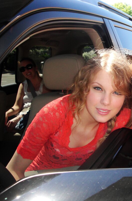 woman in red dress in car
