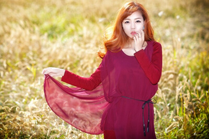 woman in red dress in field