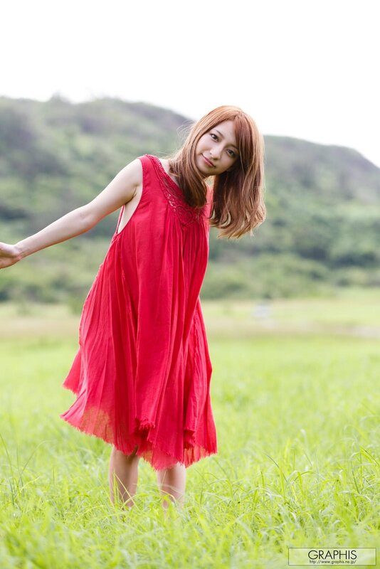 Woman in red dress in field
