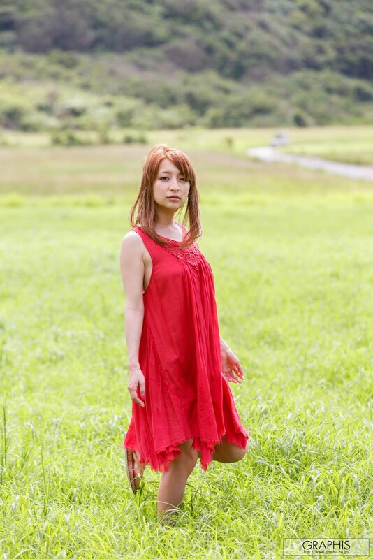 Woman in red dress in field