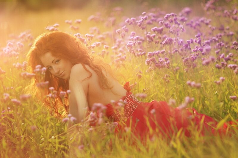 Woman in red dress in flower field