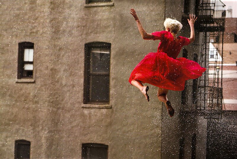 Woman in red dress jumping