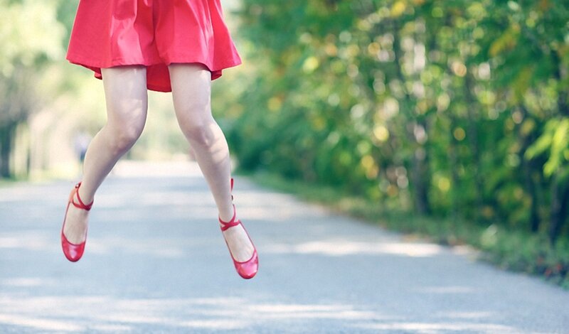 woman in red dress jumping