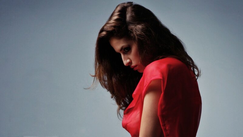woman in red dress looking down