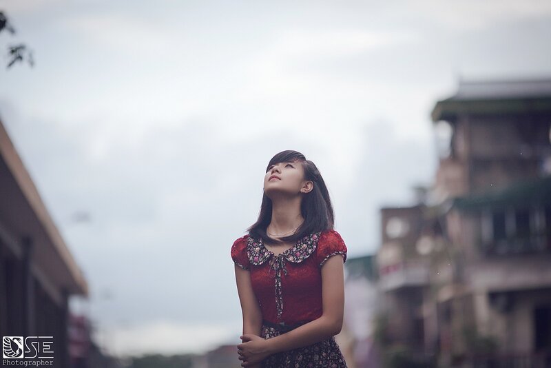 woman in red dress looking up
