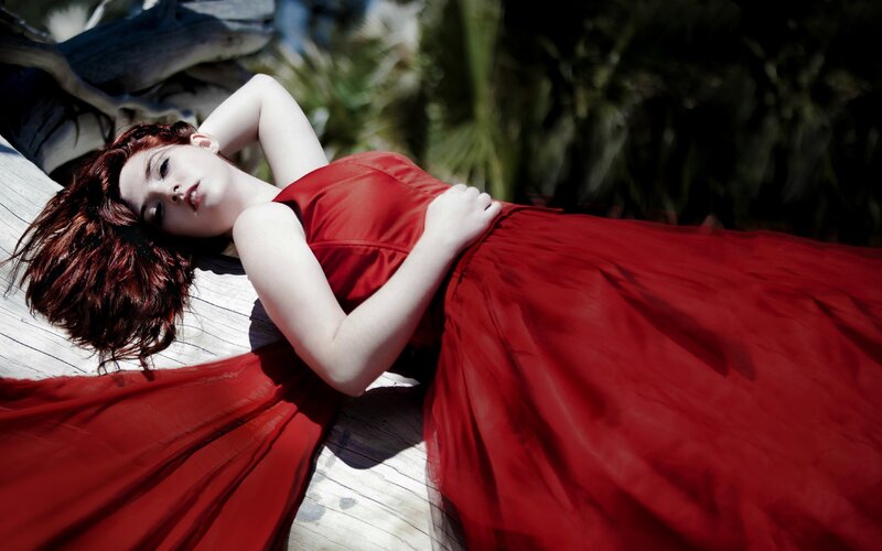 Woman in red dress lying down