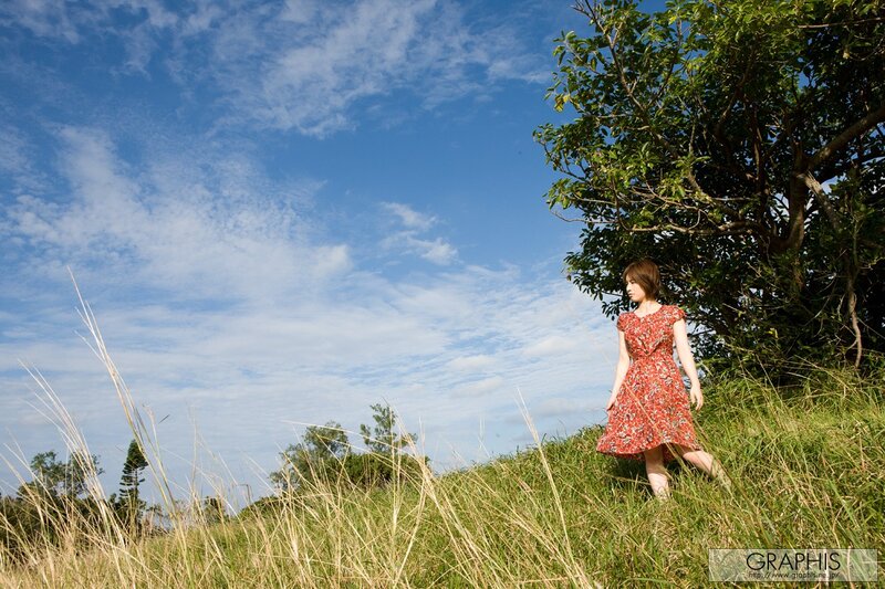 Woman in red dress on a hill