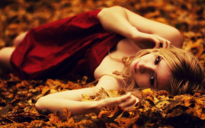 woman in red dress on autumn leaves