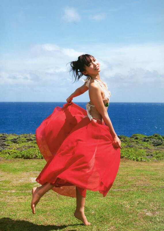 Woman in red dress on beach