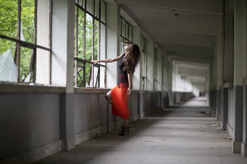 Woman in red dress on corridor