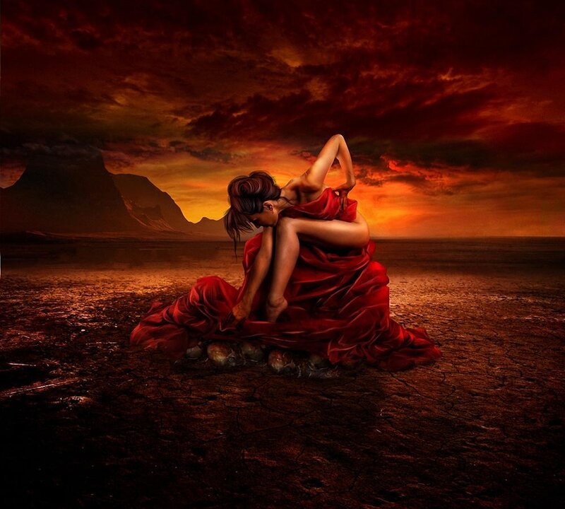 woman in red dress on cracked earth