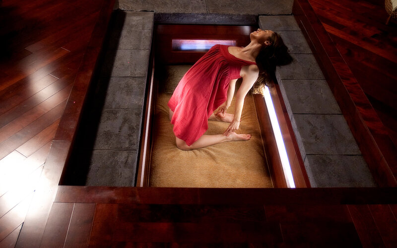 Woman in red dress on cushioned platform