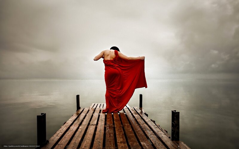 woman in red dress on dock