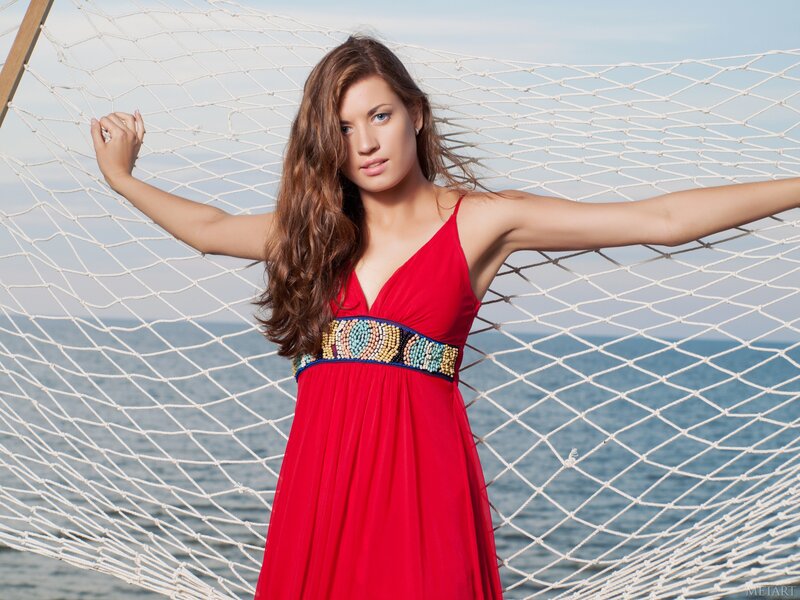 Woman in red dress on hammock