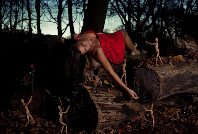 Woman in red dress on log