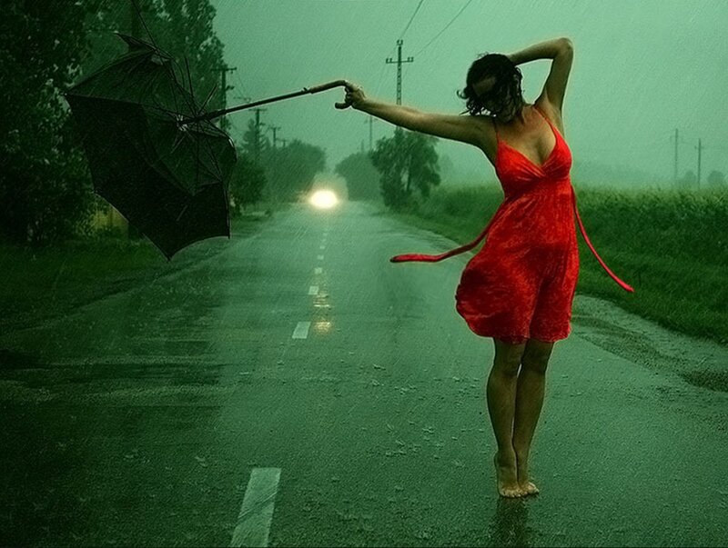 Woman in red dress on rainy road