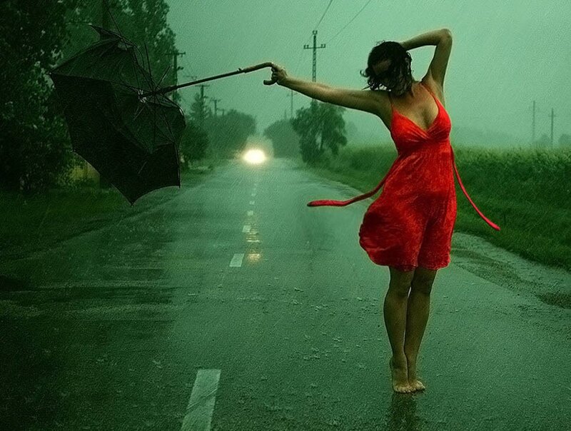 Woman in red dress on rainy road