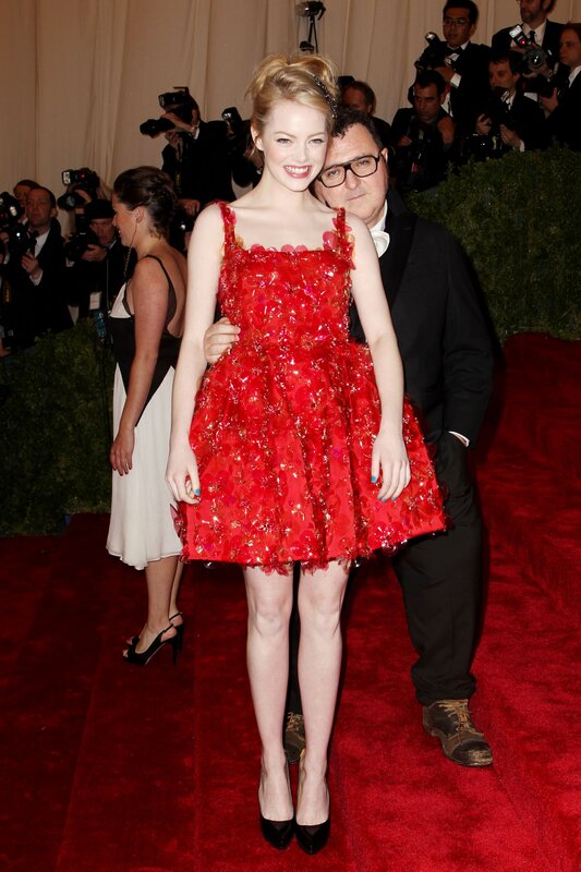 Woman in red dress on red carpet