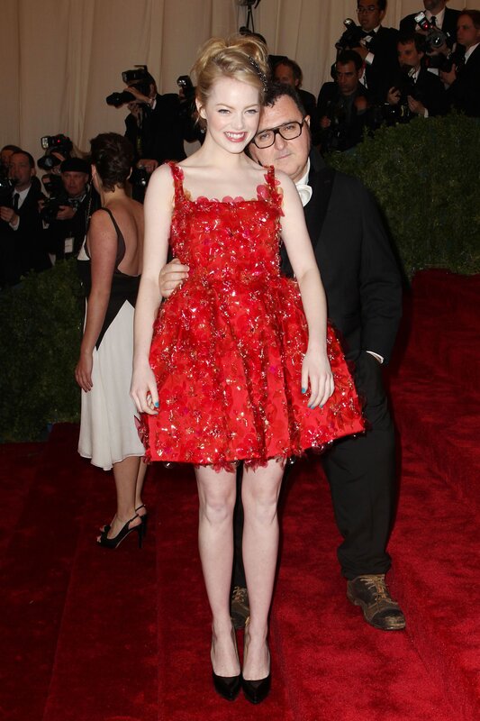 woman in red dress on red carpet