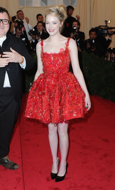 woman in red dress on red carpet