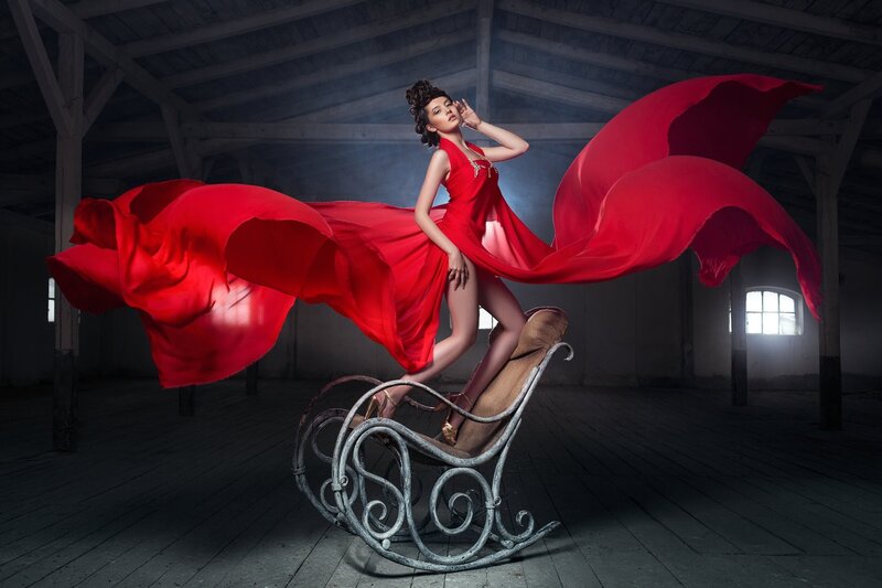 woman in red dress on rocking chair