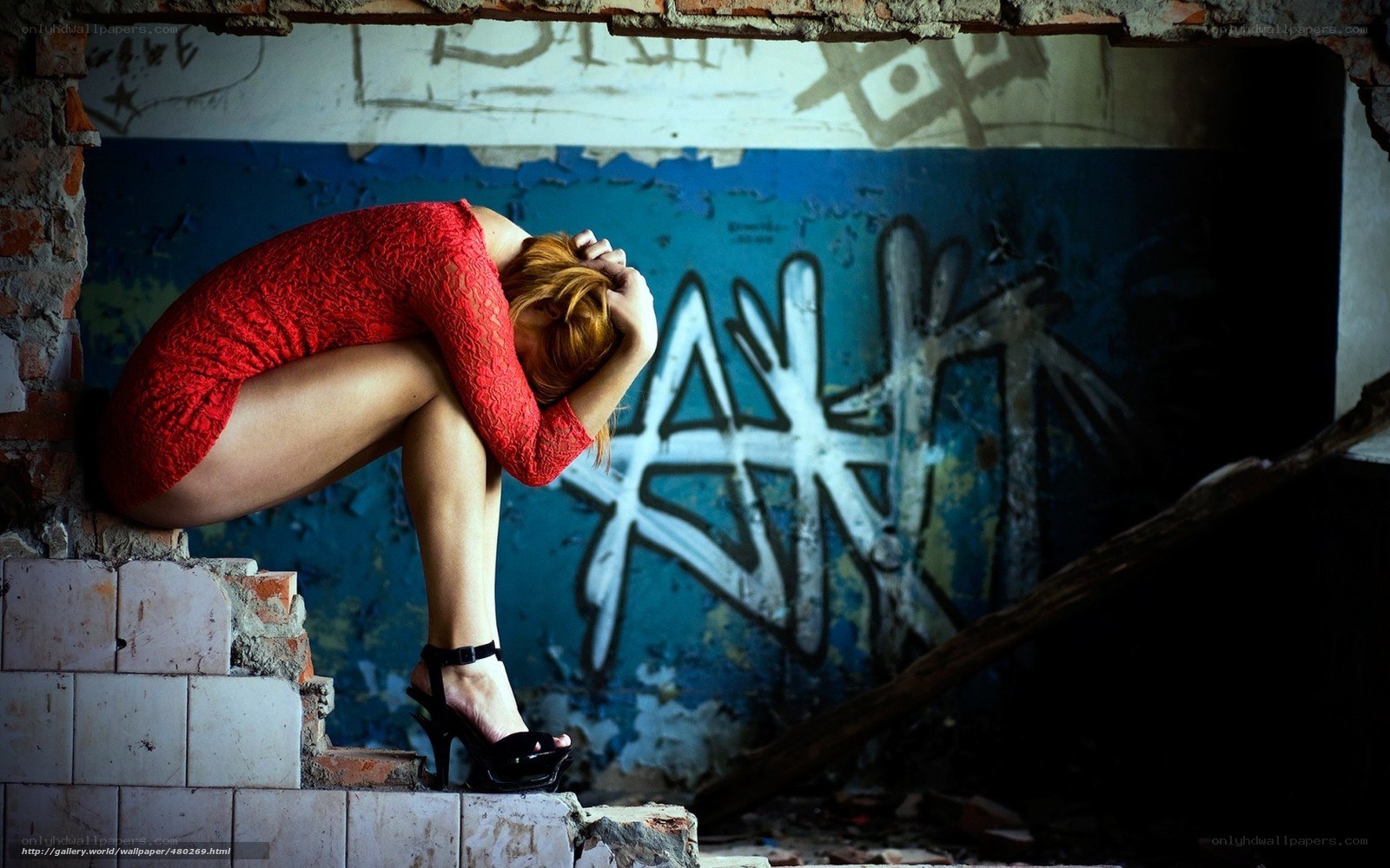 Woman in red dress on rubble