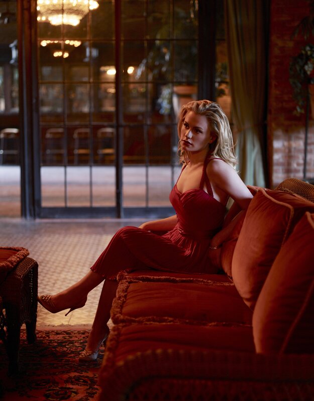 Woman in red dress on sofa