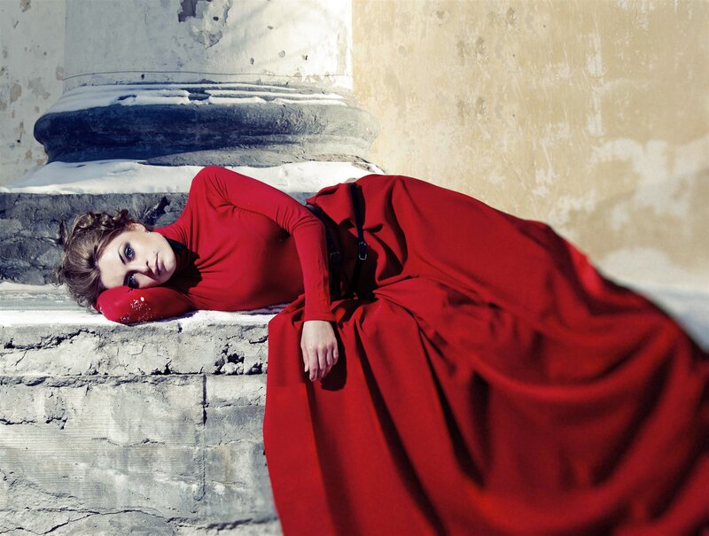 Woman in red dress on stone steps