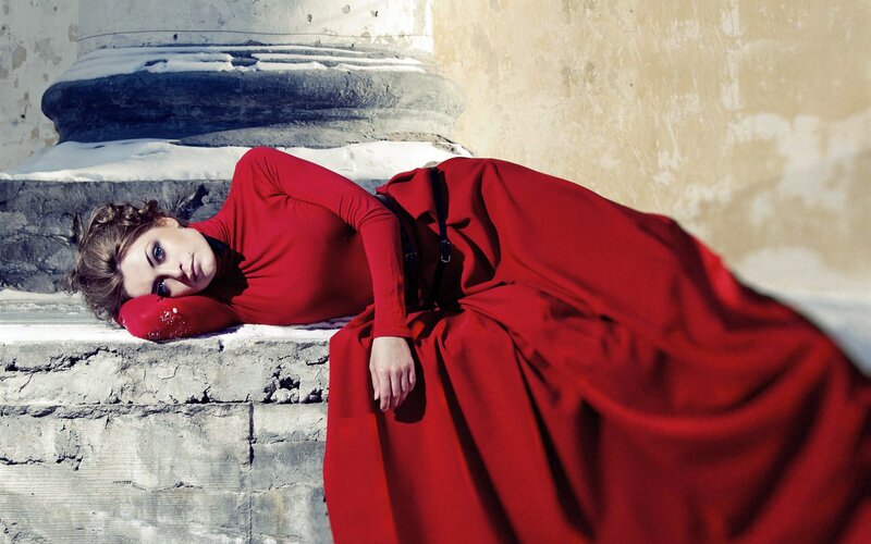 Woman in red dress on stone steps