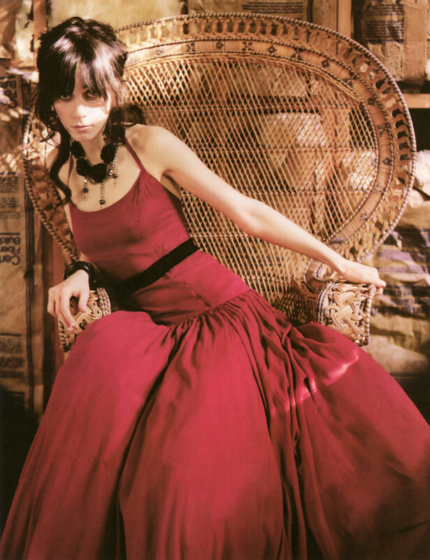 Woman in red dress on wicker chair