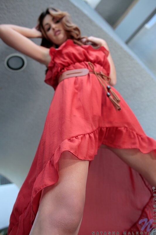 Woman in red dress posing