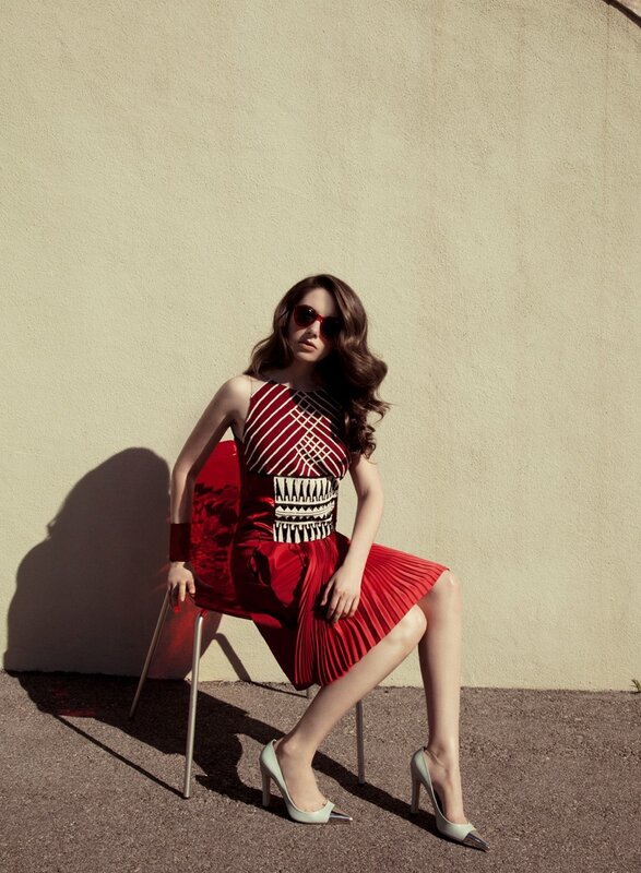 Woman in red dress sitting on chair
