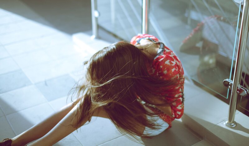 woman in red dress sitting on floor