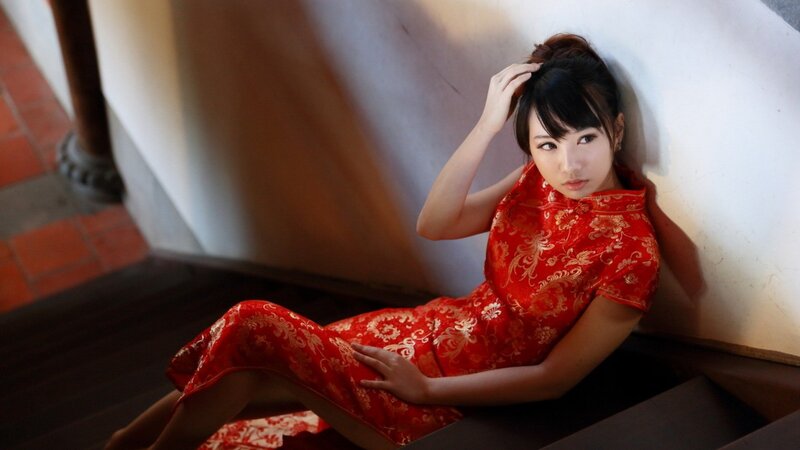 woman in red dress sitting on stairs