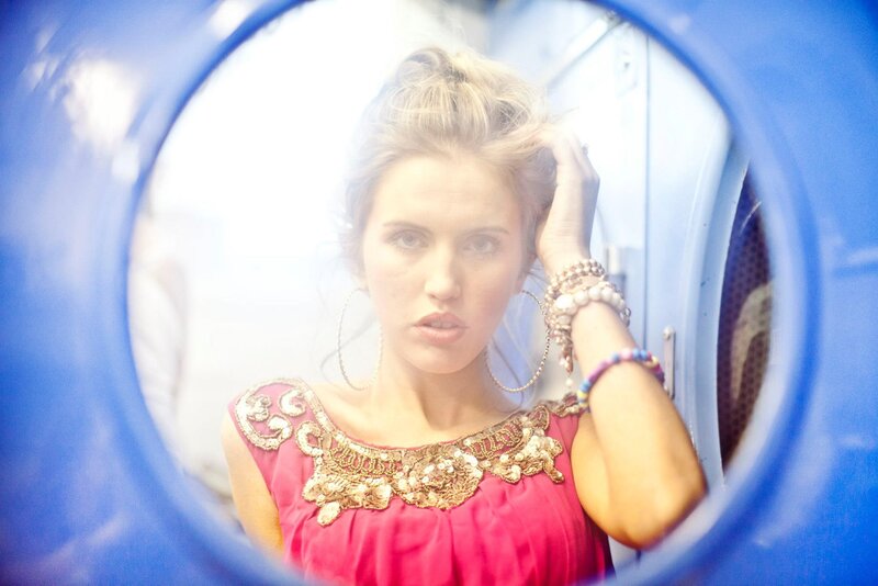 woman in red dress through blue circle