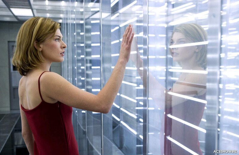 woman in red dress touching glass